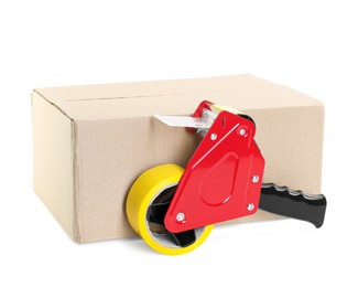 Photo of Dispenser with adhesive tape on cardboard box against white background