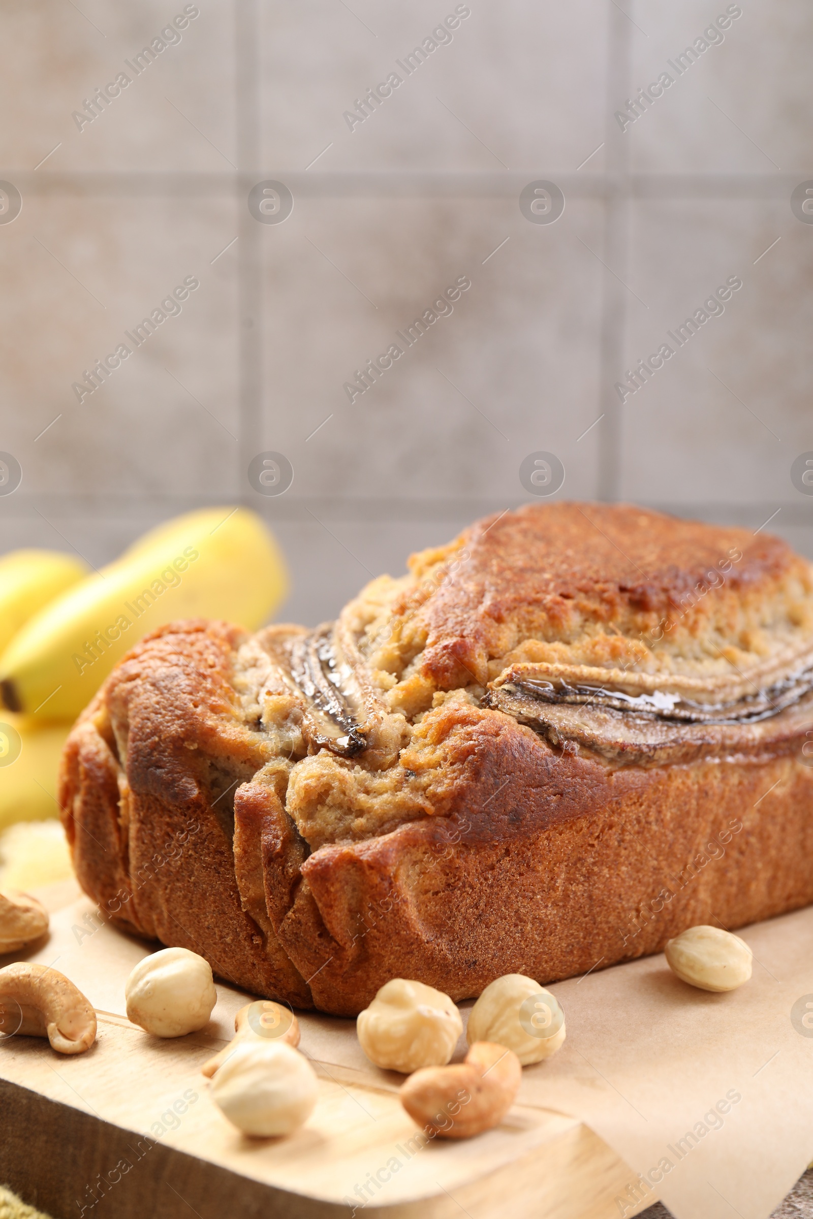 Homemade banana bread with nuts on table, closeup Photo of Homemade banana bread with nuts on table, closeup