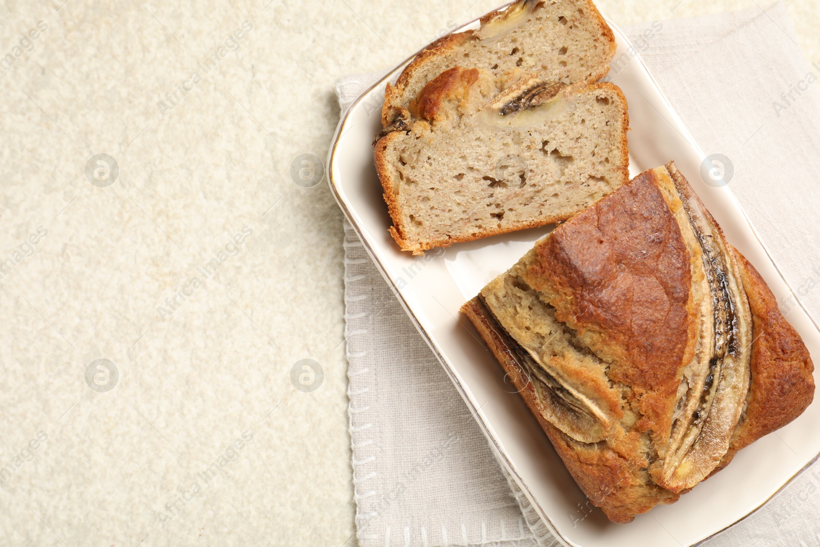 Cut banana bread on light grey table, top view. Space for text Photo of Cut banana bread on light grey table, top view. Space for text