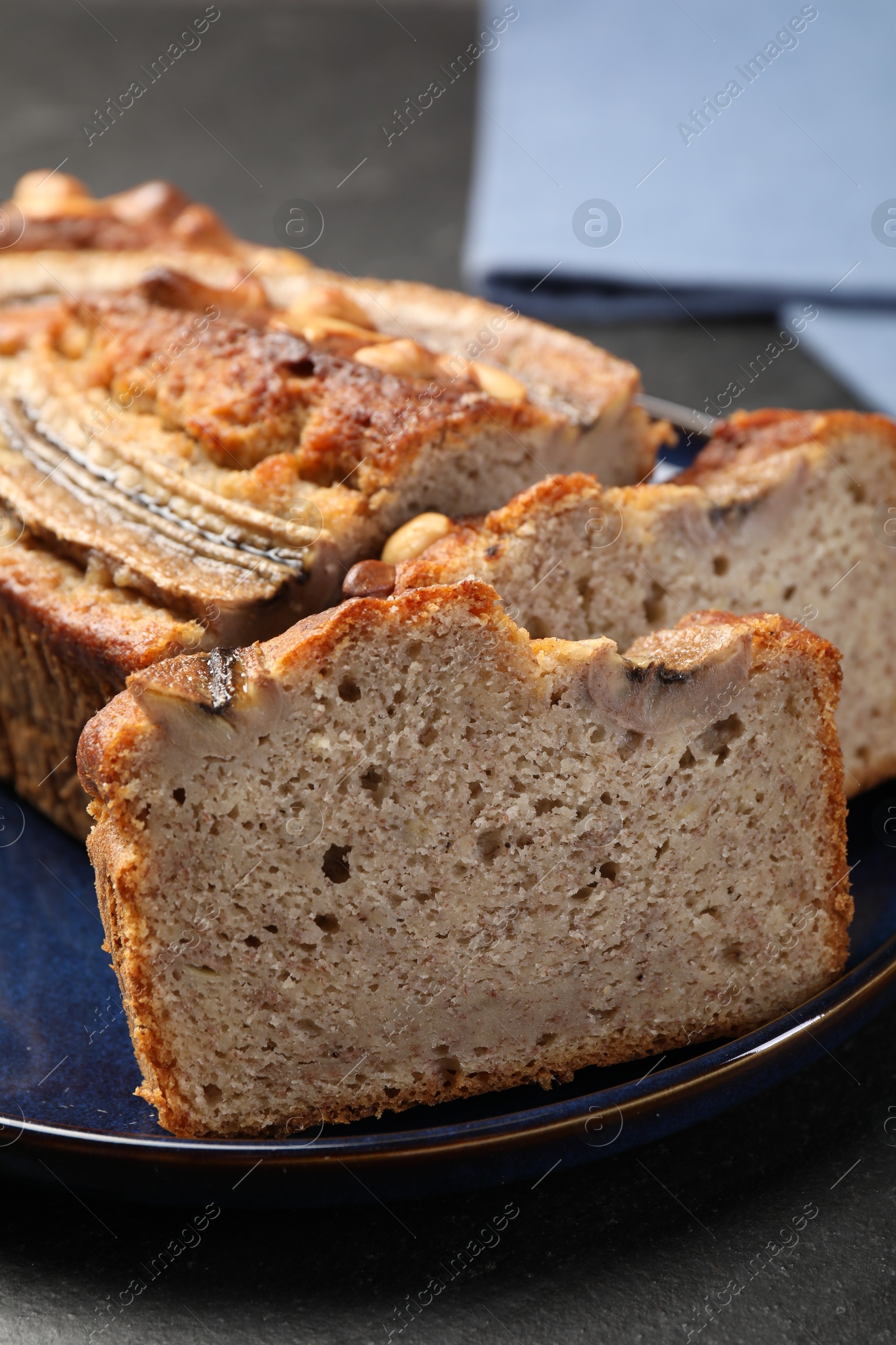 Cut banana bread with nuts on black table, closeup Photo of Cut banana bread with nuts on black table, closeup