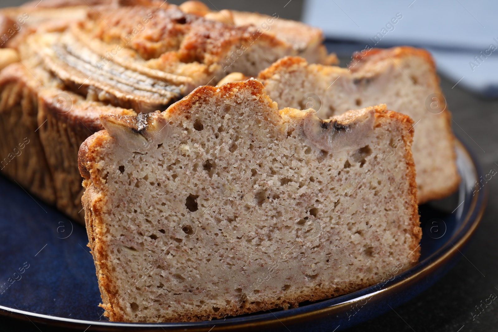Cut banana bread with nuts on table, closeup Photo of Cut banana bread with nuts on table, closeup