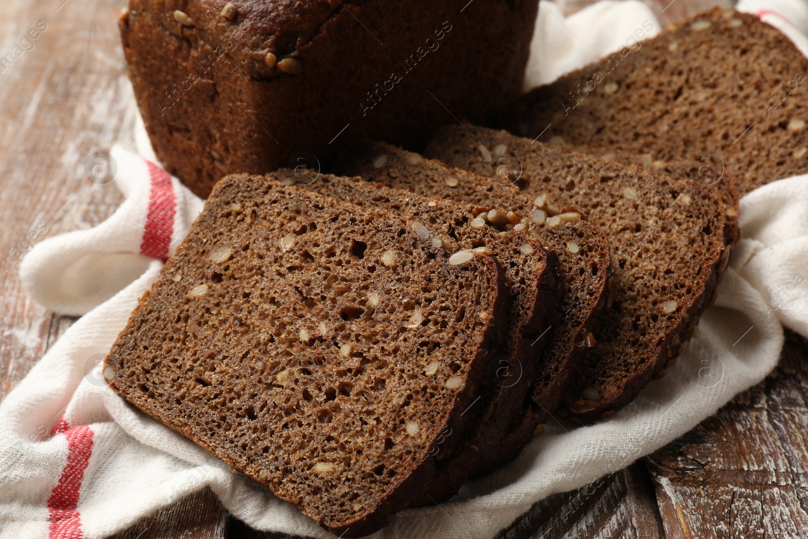 Photo of Pieces of fresh bread on wooden table, closeup