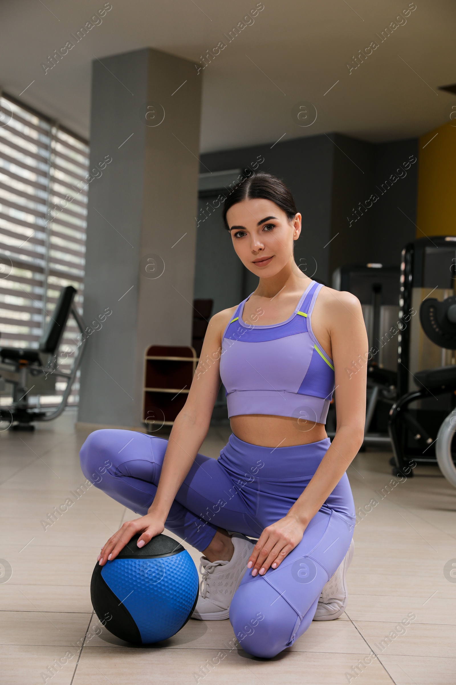 Young woman with medicine ball in gym Photo of Young woman with medicine ball in gym