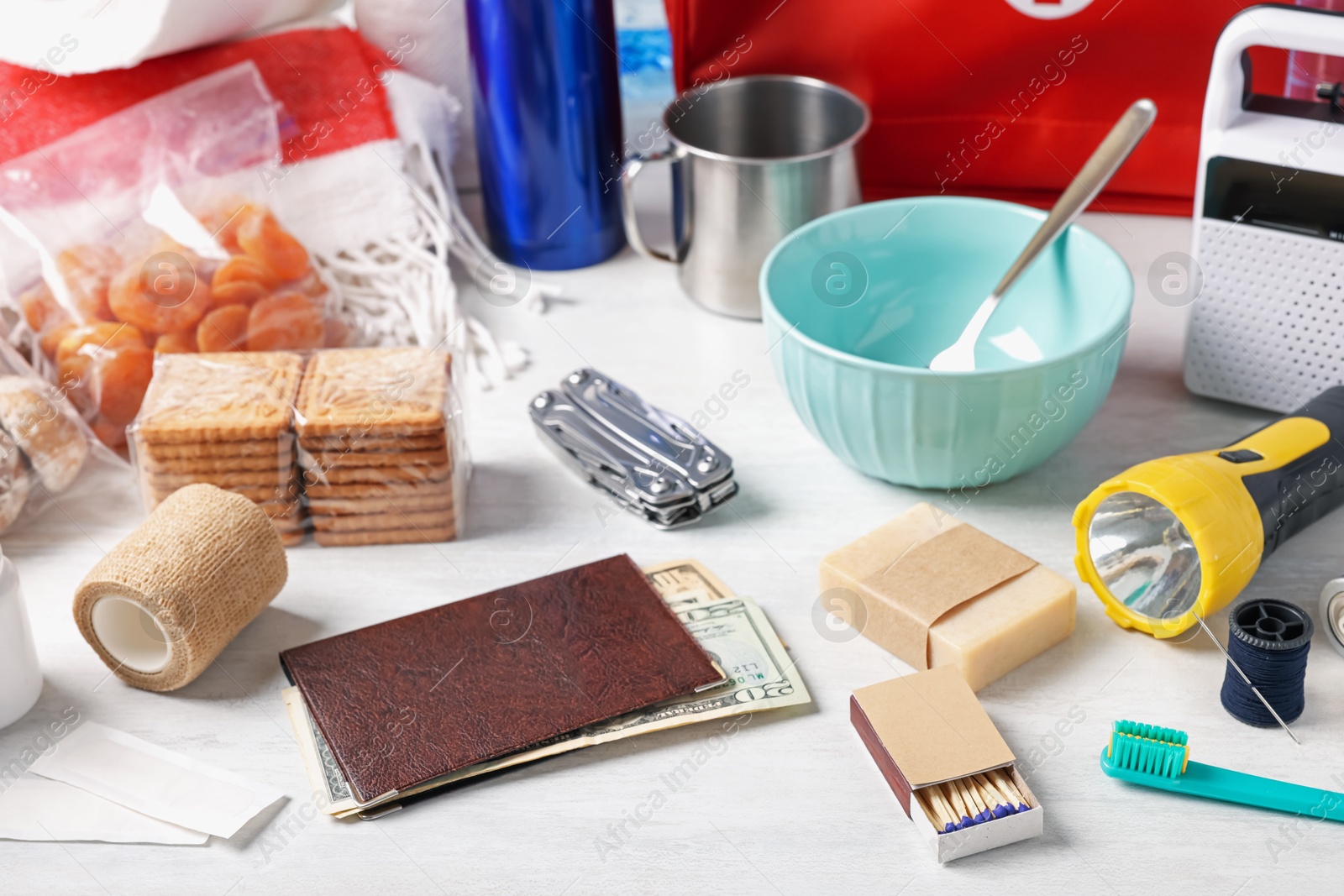 Disaster supply kit for earthquake on white wooden table Photo of Disaster supply kit for earthquake on white wooden table