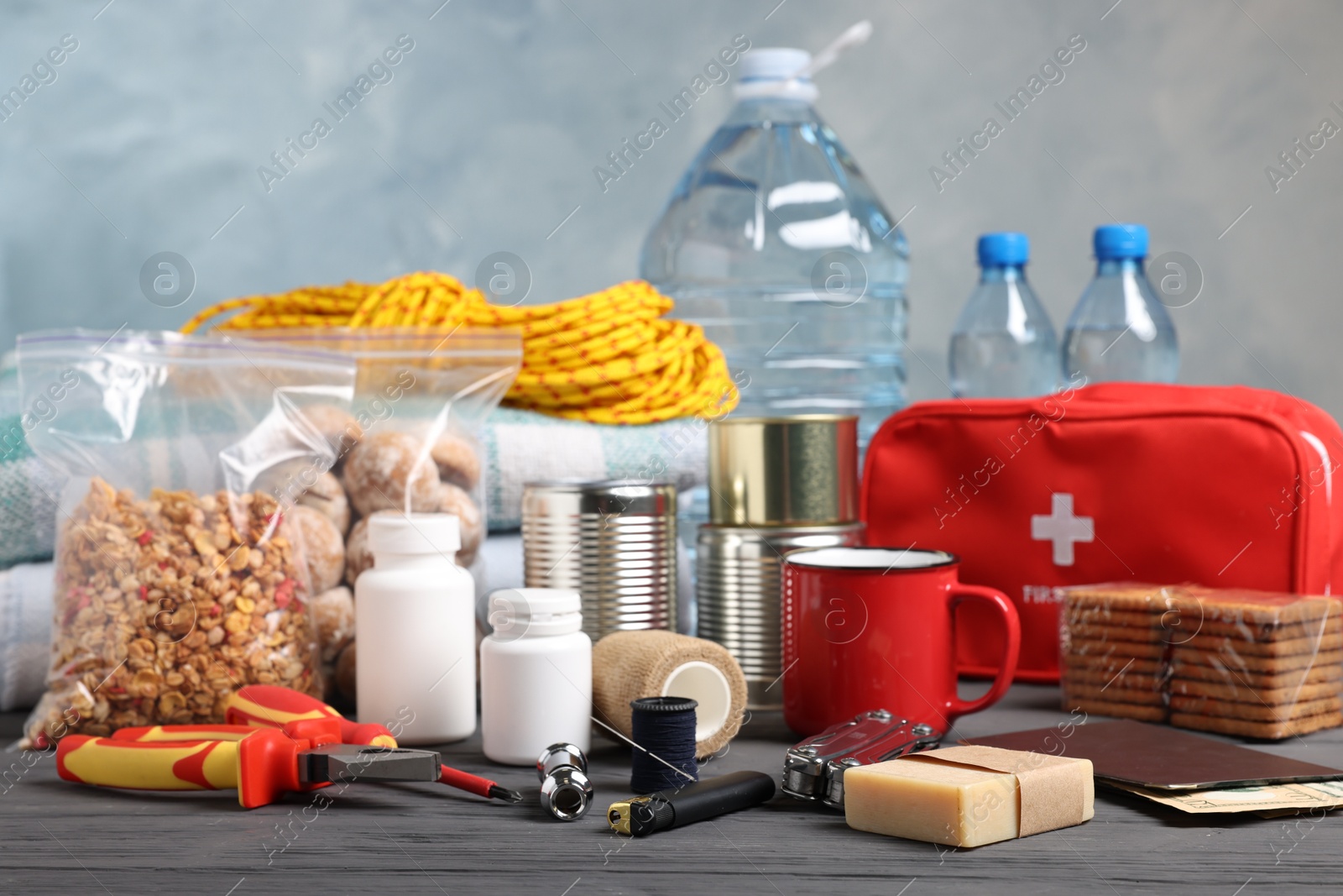 Disaster supply kit for earthquake on black wooden table Photo of Disaster supply kit for earthquake on black wooden table