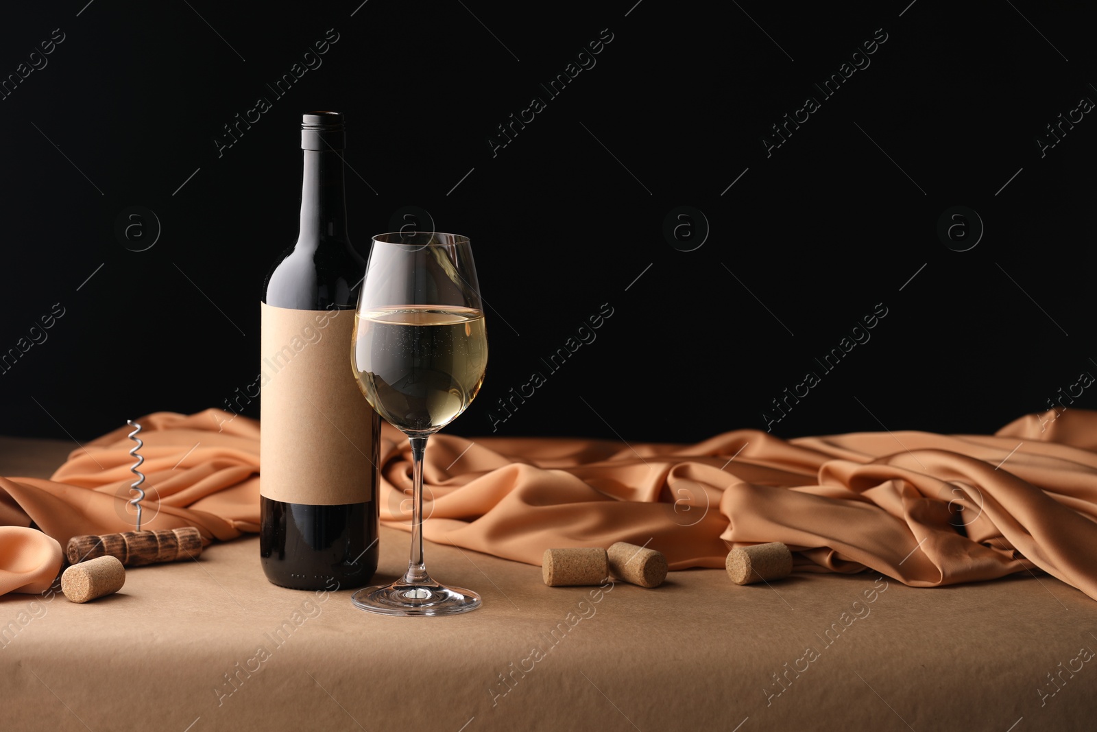 Bottle of wine, wineglass and cloth on brown table, space for text Photo of Bottle of wine, wineglass and cloth on brown table, space for text