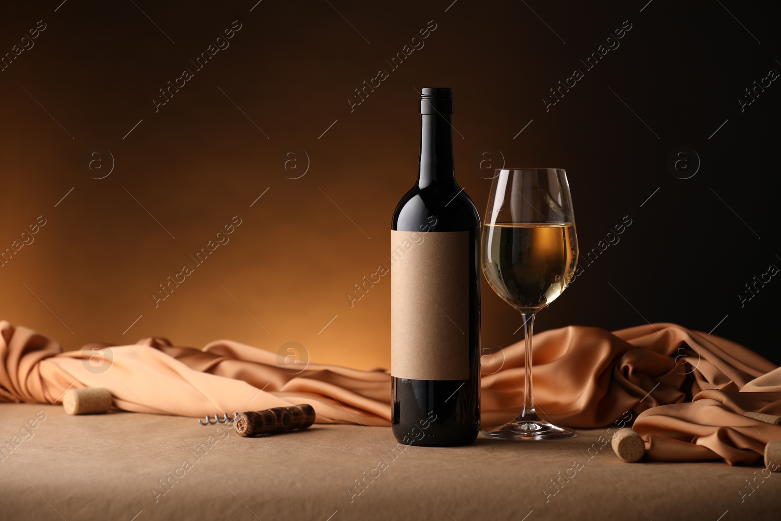 Bottle of wine, wineglass and cloth on brown table, space for text Photo of Bottle of wine, wineglass and cloth on brown table, space for text