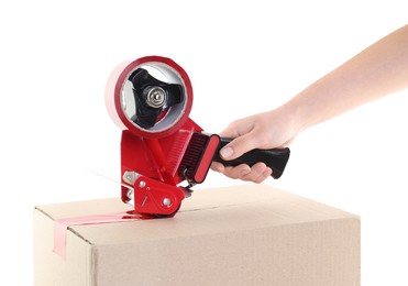 Photo of Woman using dispenser with adhesive tape to seal cardboard box on white background, closeup