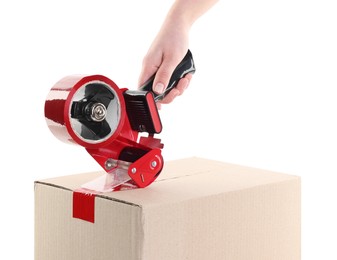 Photo of Woman using dispenser with adhesive tape to seal cardboard box on white background, closeup