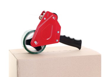 Photo of Dispenser with adhesive tape on cardboard box against white background