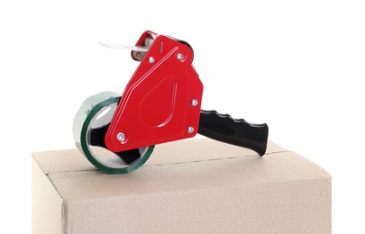 Photo of Dispenser with adhesive tape on cardboard box against white background