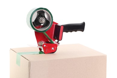 Photo of Dispenser with adhesive tape on cardboard box against white background