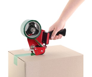 Photo of Woman using dispenser with adhesive tape to seal cardboard box on white background, closeup
