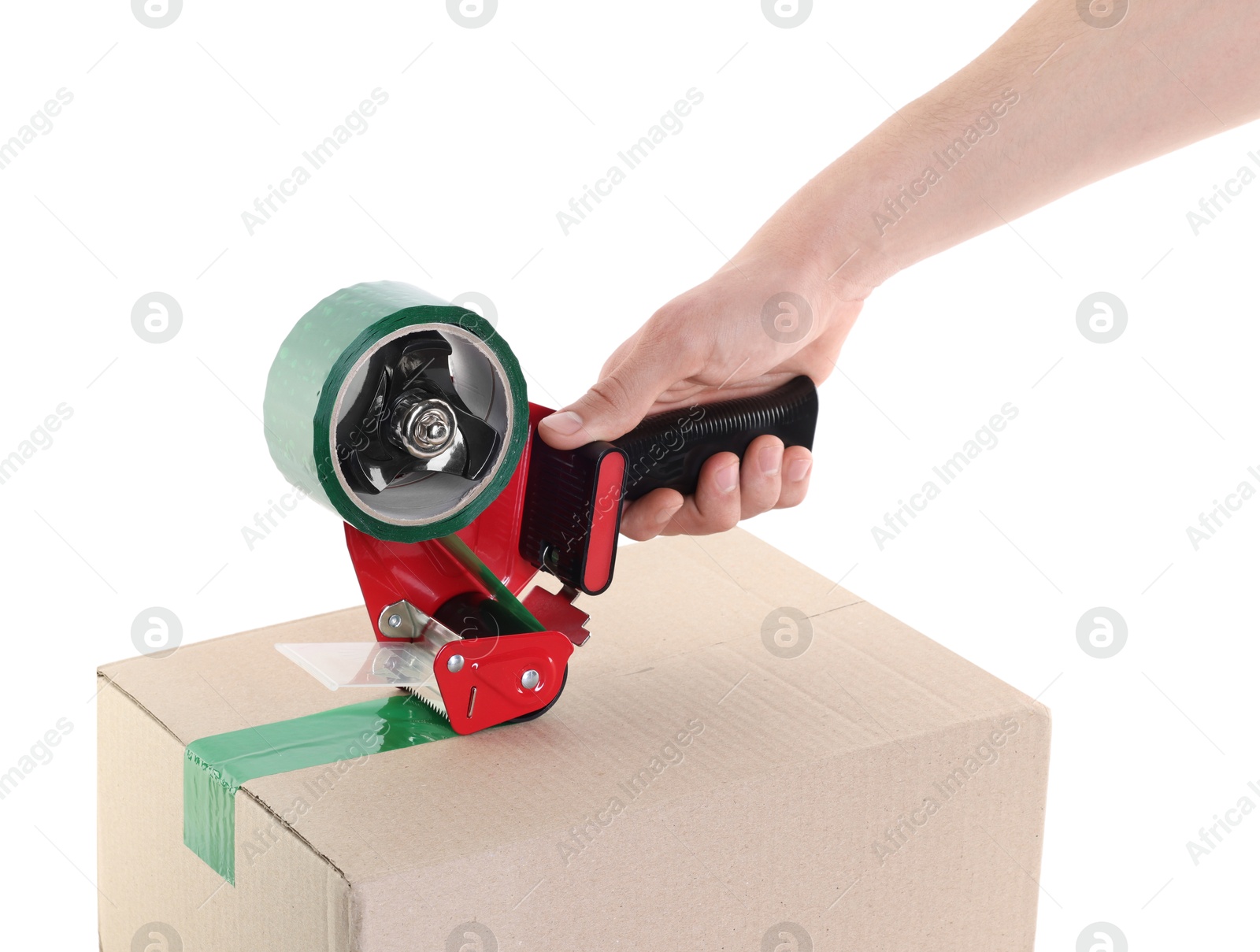 Photo of Man using dispenser with adhesive tape to seal cardboard box on white background, closeup