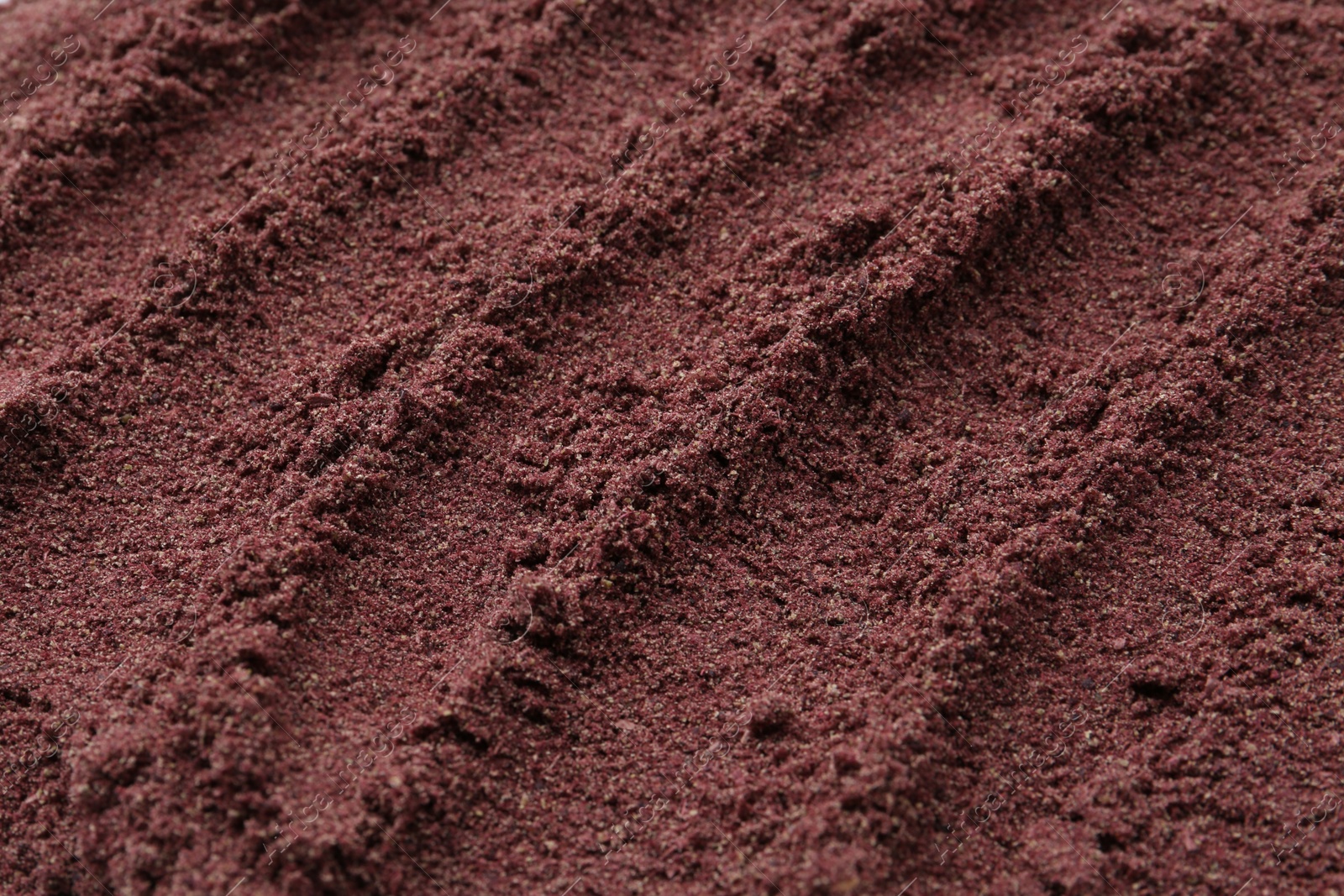 Superfood. Black currant powder as background, above view Photo of Superfood. Black currant powder as background, above view