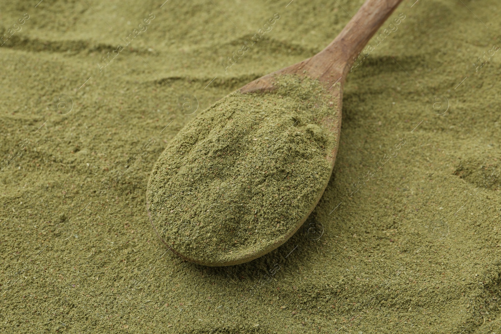 Superfood. Green onion powder and spoon, closeup Photo of Superfood. Green onion powder and spoon, closeup