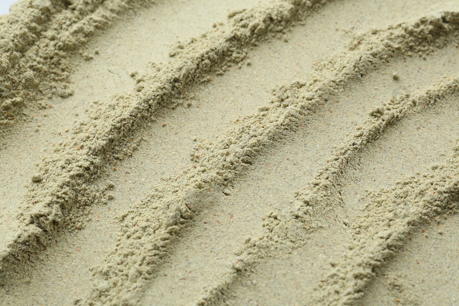 Superfood. Light green powder as background, above view Photo of Superfood. Light green powder as background, above view