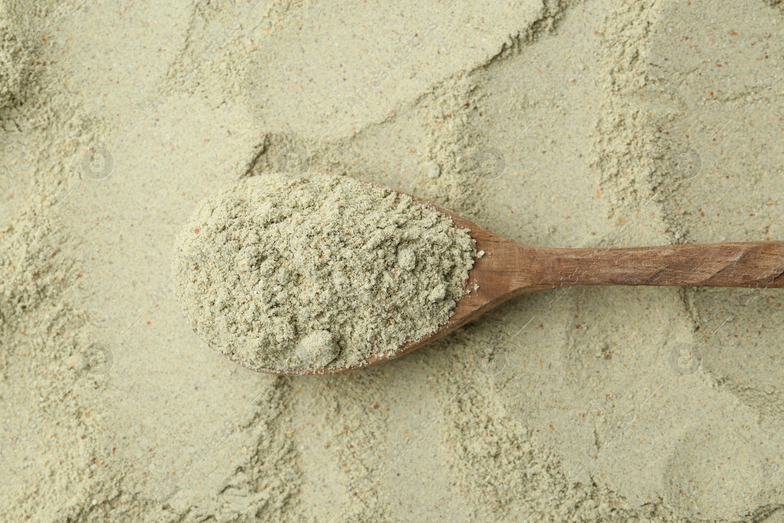 Superfood. Light green powder and spoon, top view Photo of Superfood. Light green powder and spoon, top view