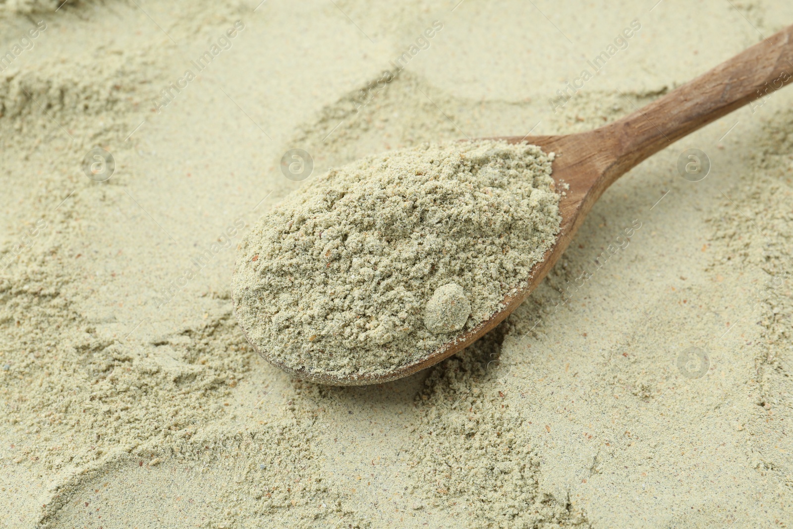 Superfood. Light green powder and spoon, closeup Photo of Superfood. Light green powder and spoon, closeup