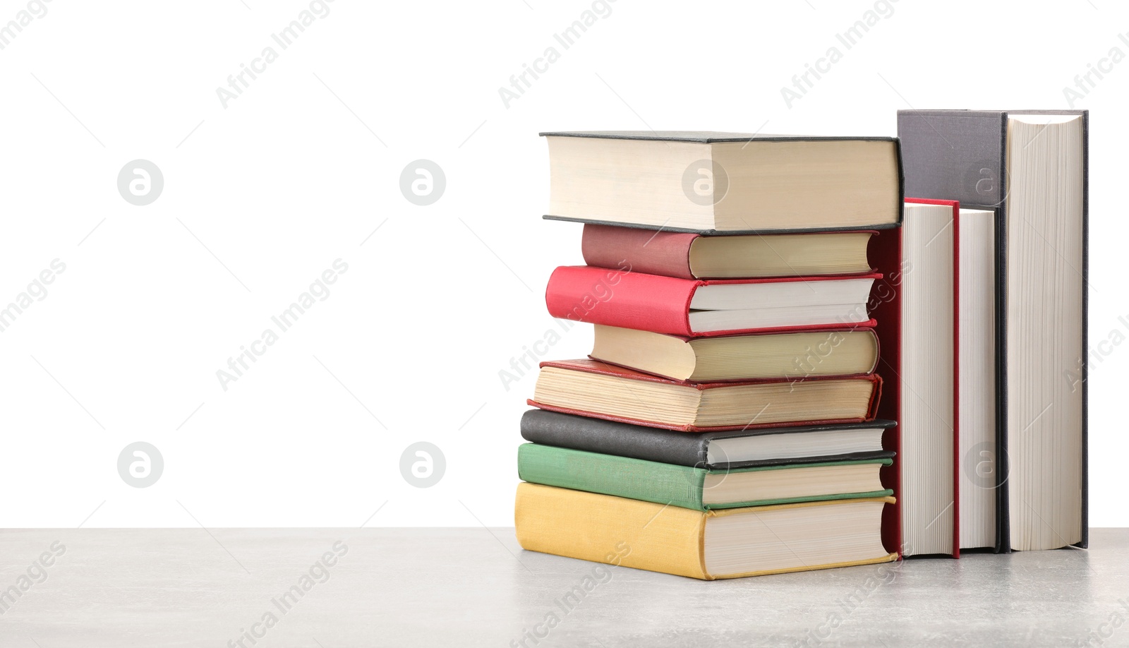 Old books on light grey table against white background Photo of Old books on light grey table against white background