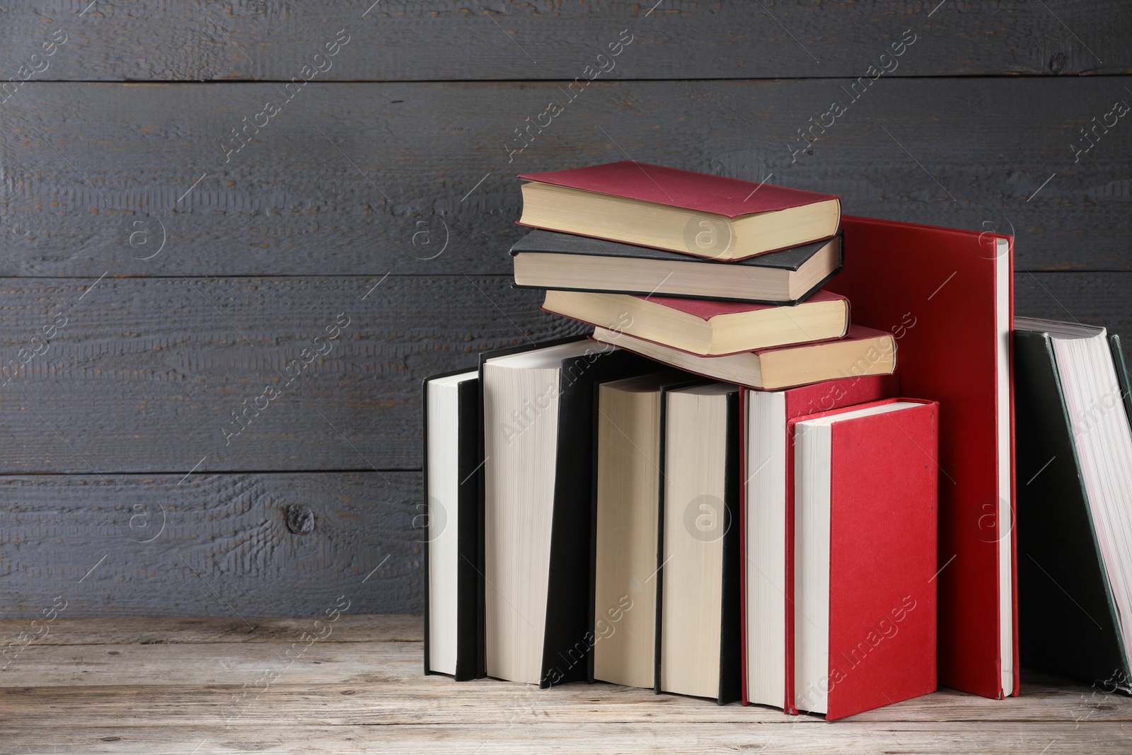 Many different old books on wooden table, space for text Photo of Many different old books on wooden table, space for text