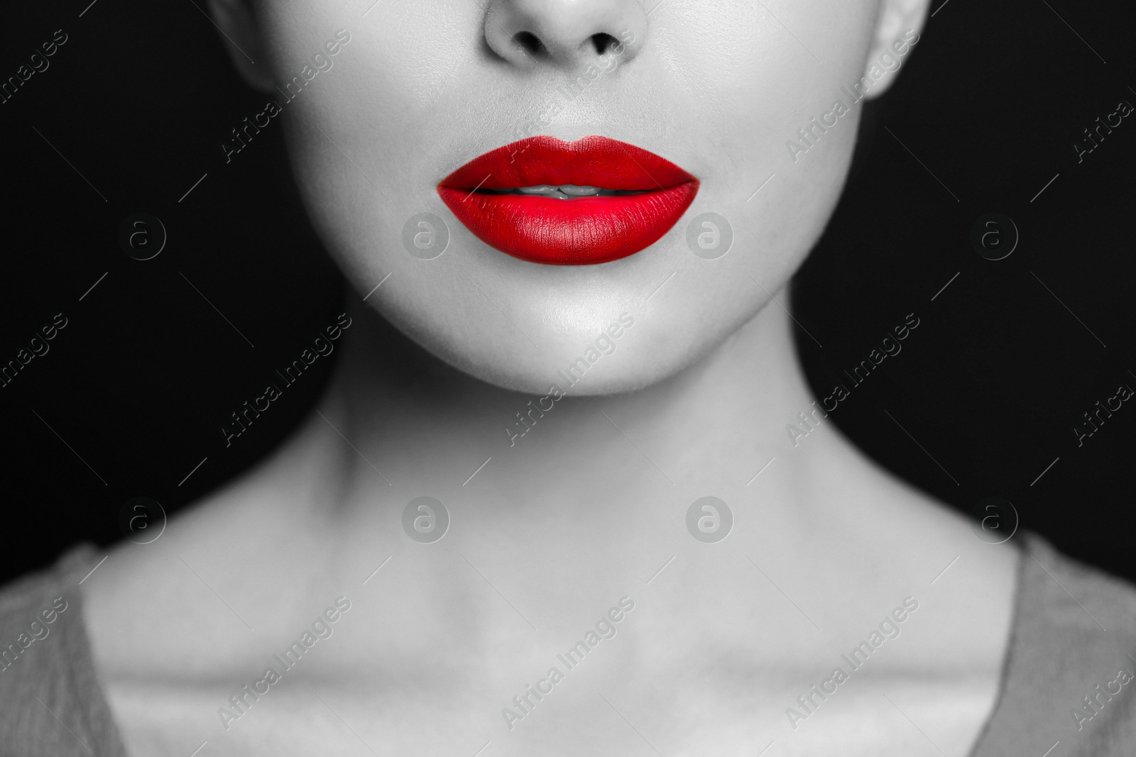 Young woman with beautiful red lips, closeup. Black and white effect with color accent Image of Young woman with beautiful red lips, closeup. Black and white effect with color accent