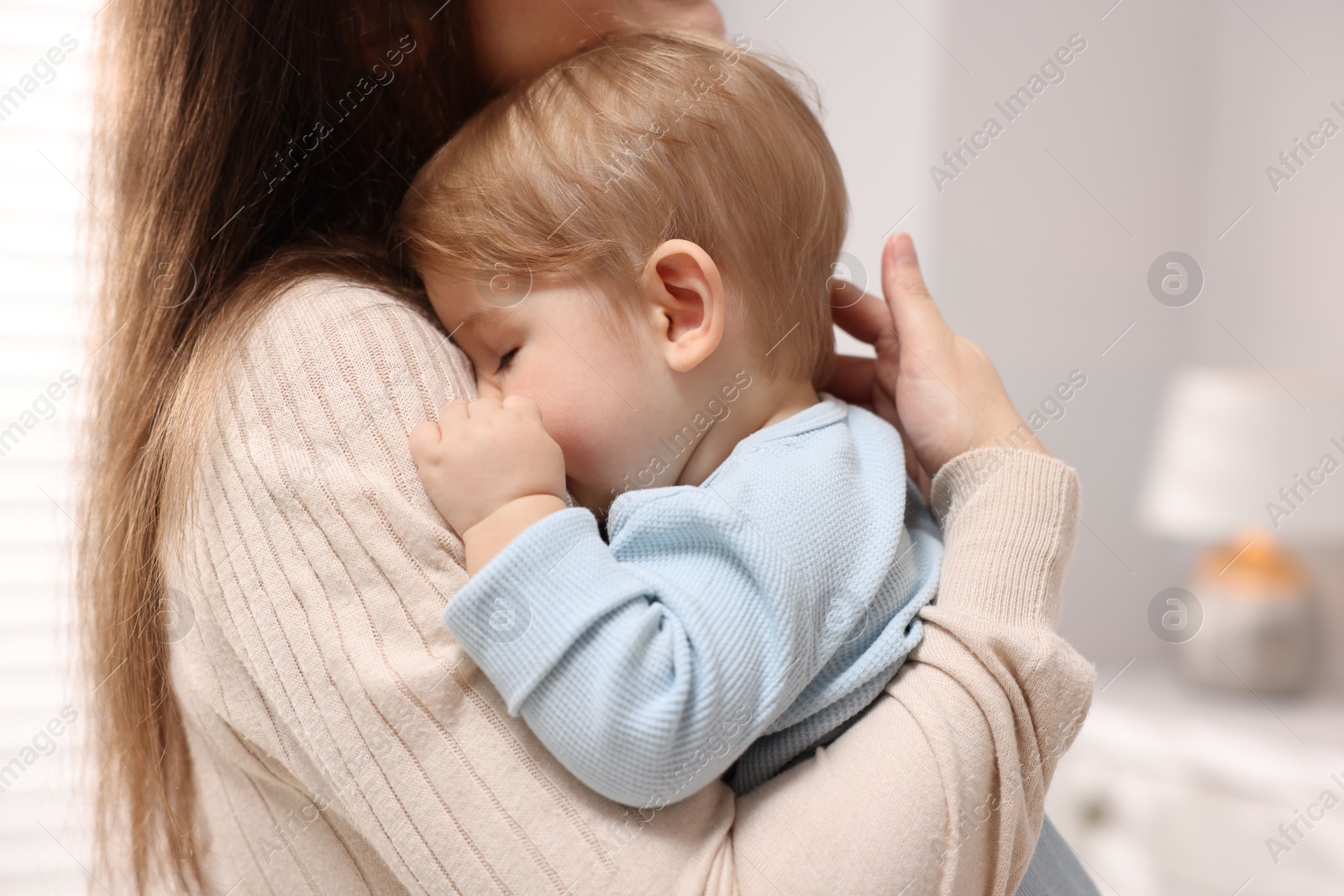 Mother with her cute little baby at home, closeup Photo of Mother with her cute little baby at home, closeup
