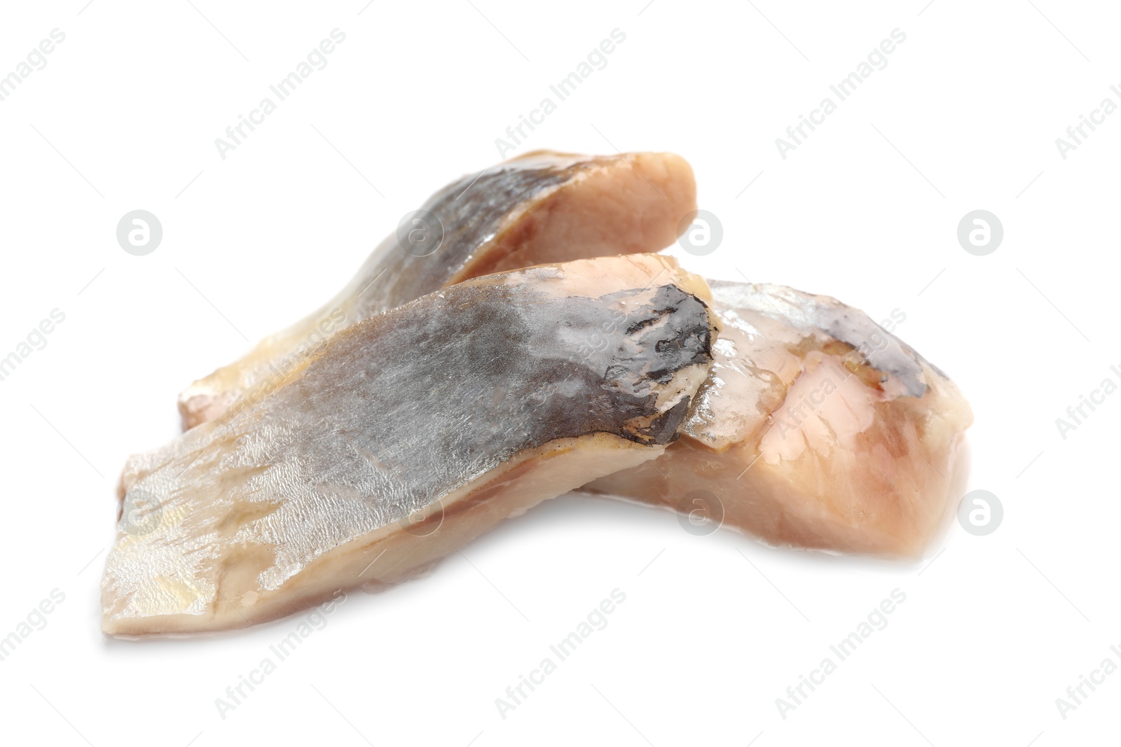 Pieces of delicious herring isolated on white Photo of Pieces of delicious herring isolated on white