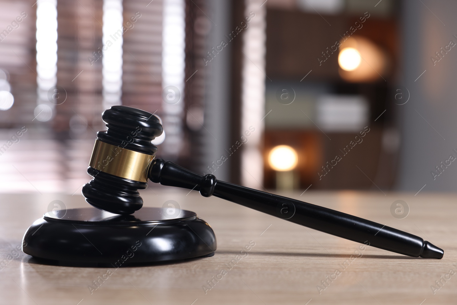 Judge's gavel and sound block on wooden table against blurred background, closeup Photo of Judge's gavel and sound block on wooden table against blurred background, closeup