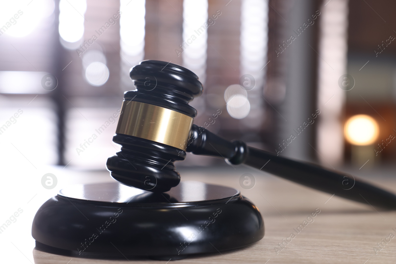 Judge's gavel and sound block on wooden table against blurred background, closeup Photo of Judge's gavel and sound block on wooden table against blurred background, closeup