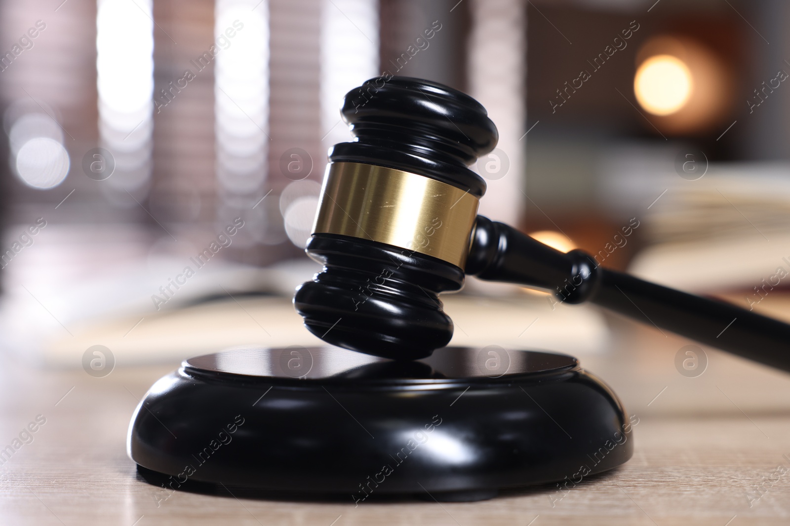 Judge's gavel and sound block on wooden table against blurred background, closeup Photo of Judge's gavel and sound block on wooden table against blurred background, closeup