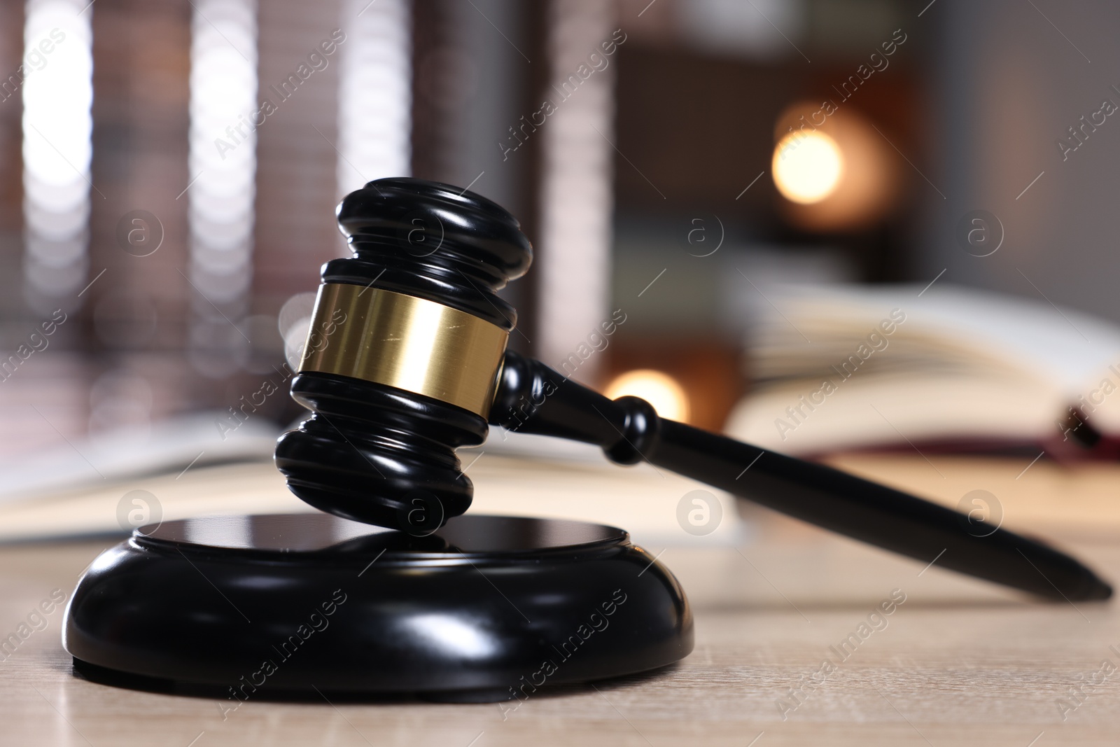 Judge's gavel and sound block on wooden table against blurred background, closeup Photo of Judge's gavel and sound block on wooden table against blurred background, closeup