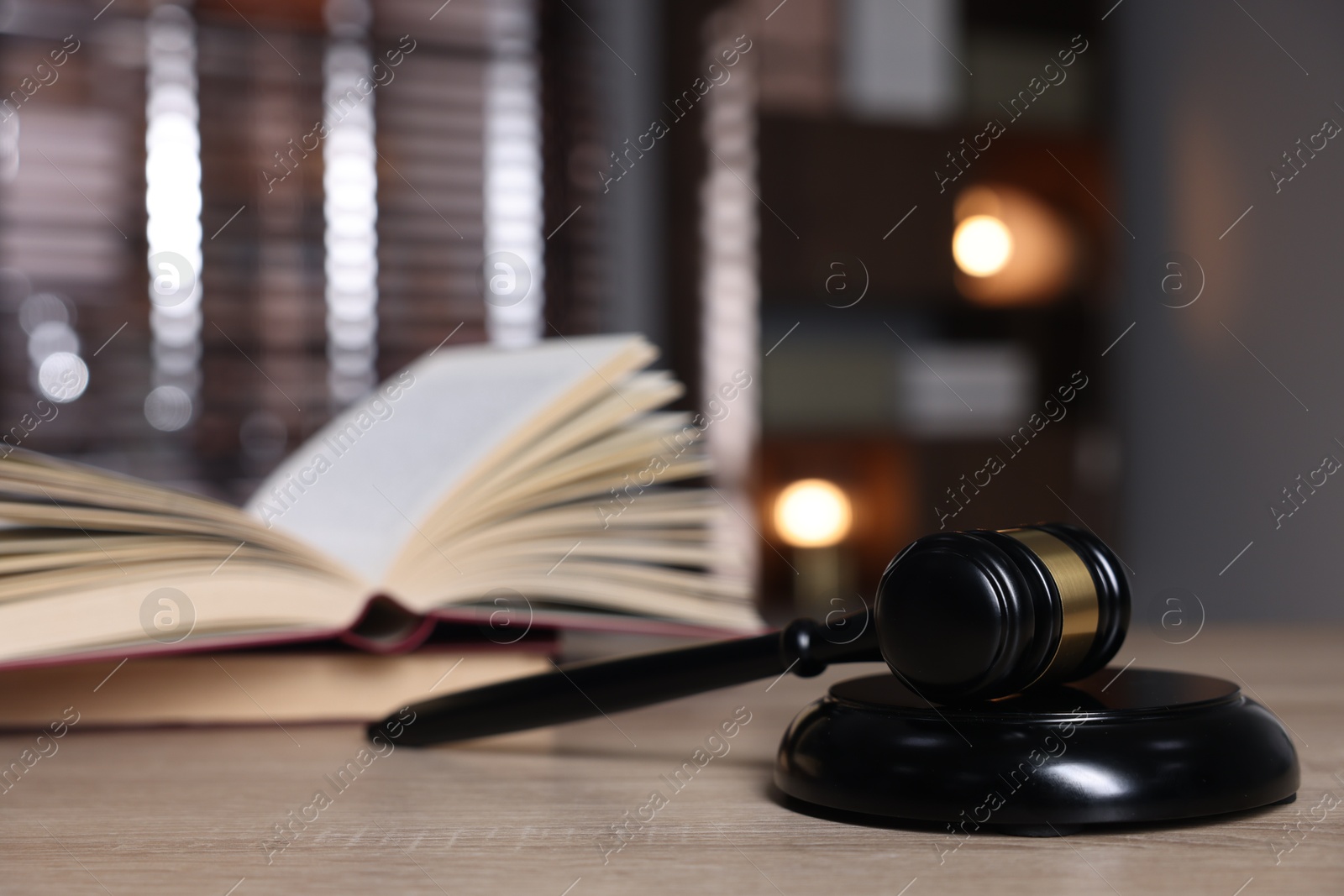 Judge's gavel, sound block and book on wooden table against blurred background, selective focus Photo of Judge's gavel, sound block and book on wooden table against blurred background, selective focus