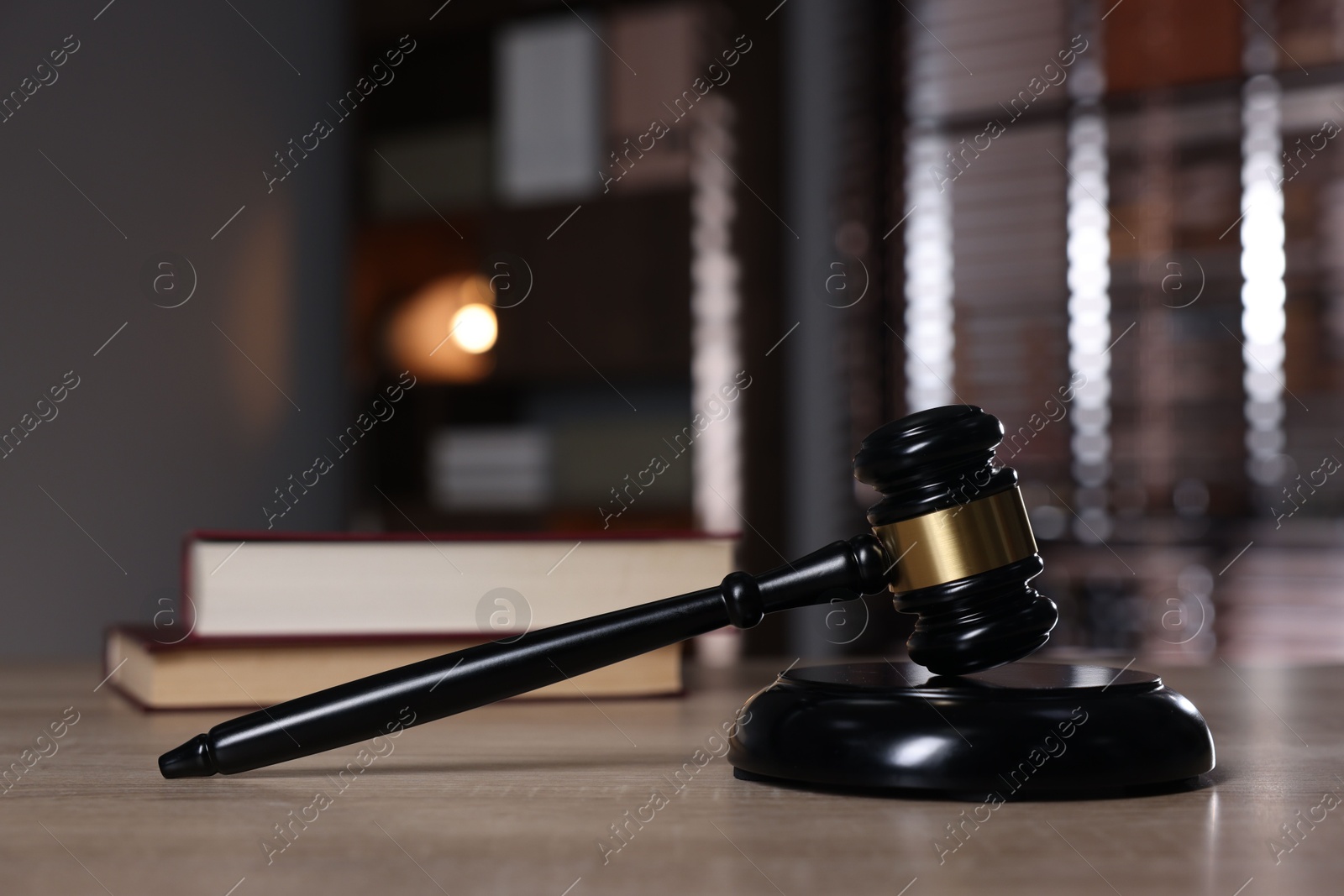 Judge's gavel and sound block on wooden table against blurred background, closeup Photo of Judge's gavel and sound block on wooden table against blurred background, closeup