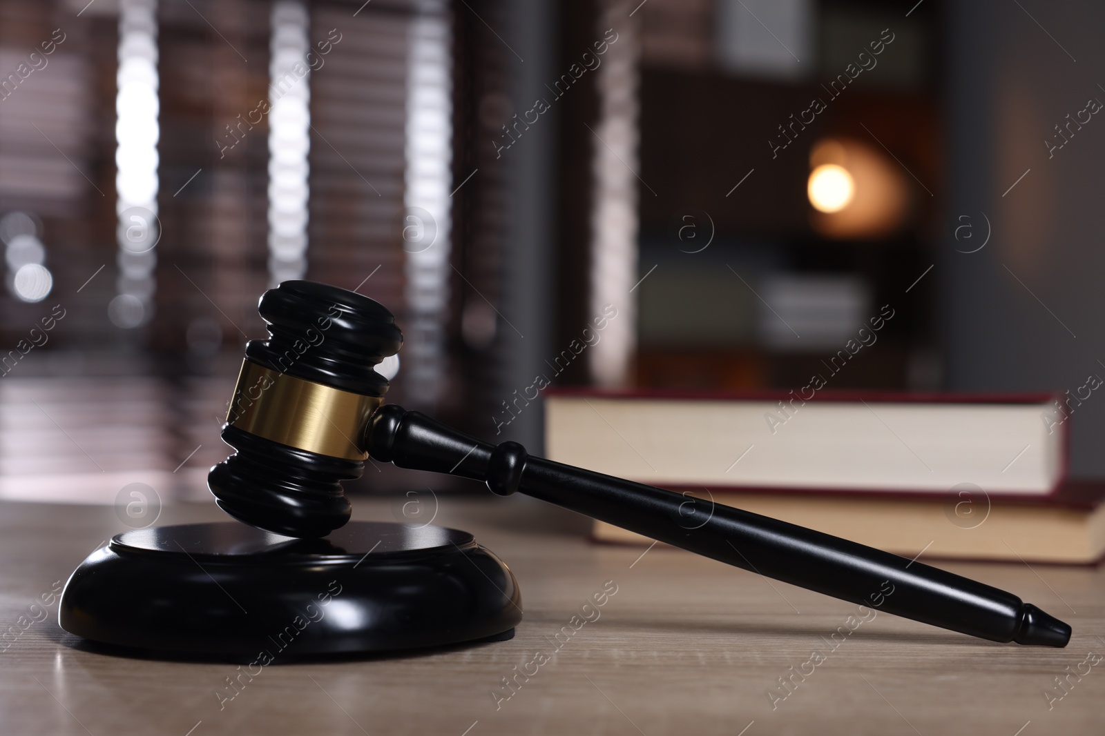 Judge's gavel and sound block on wooden table against blurred background, closeup Photo of Judge's gavel and sound block on wooden table against blurred background, closeup