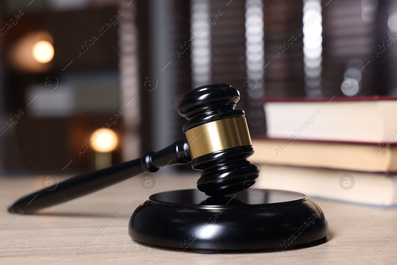 Judge's gavel and sound block on wooden table against blurred background, closeup Photo of Judge's gavel and sound block on wooden table against blurred background, closeup