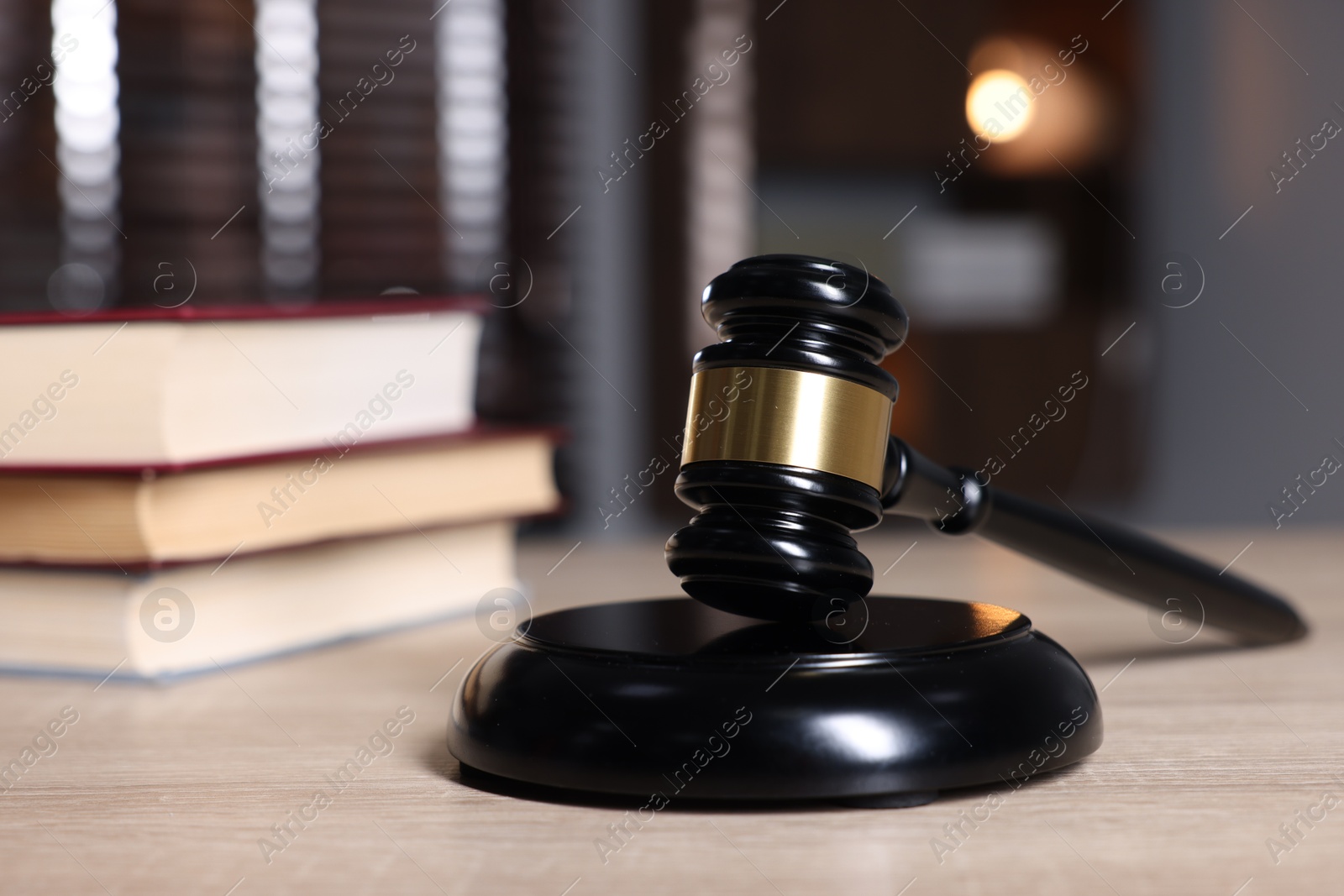 Judge's gavel and sound block on wooden table against blurred background, closeup Photo of Judge's gavel and sound block on wooden table against blurred background, closeup