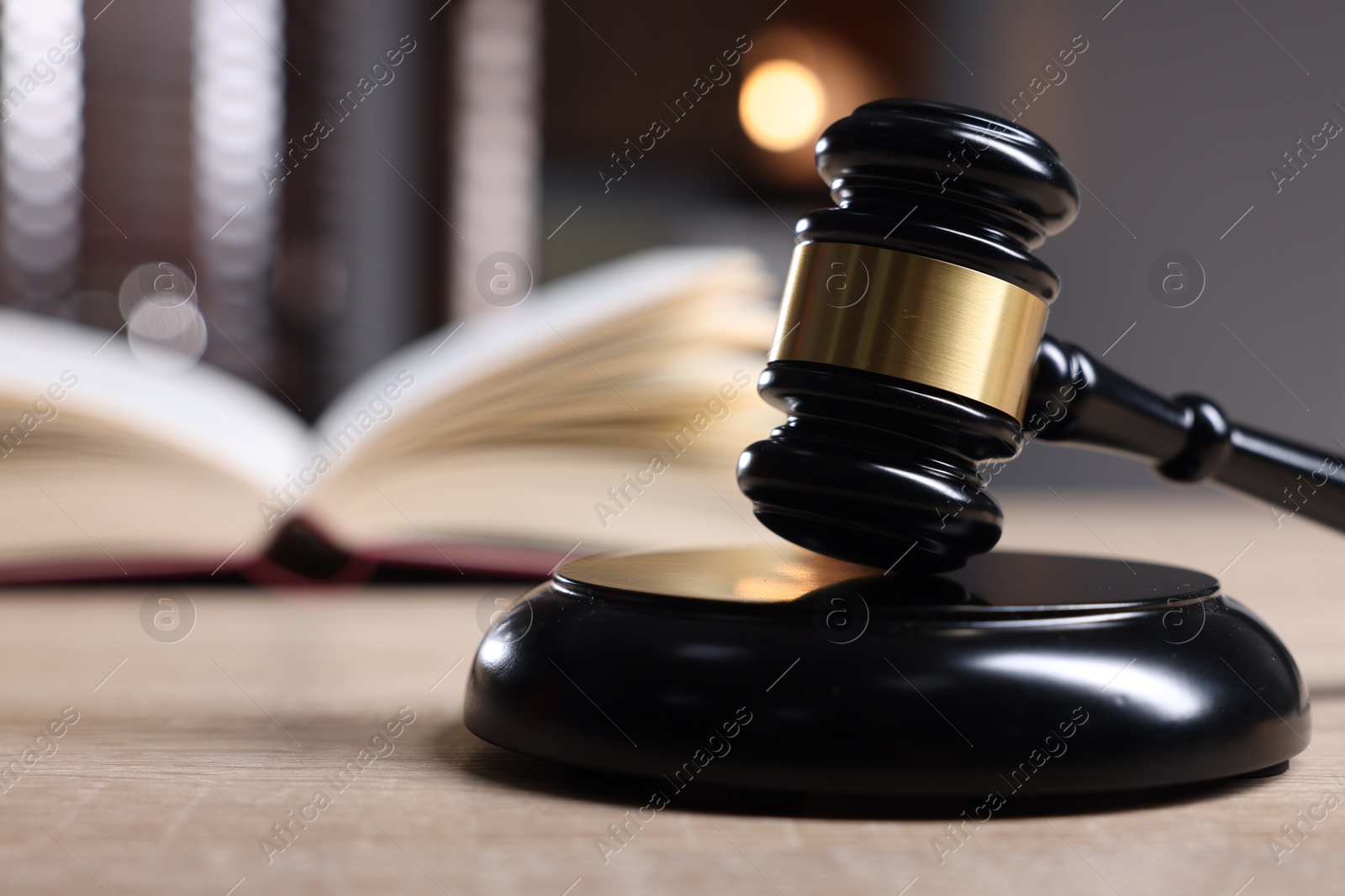 Judge's gavel and sound block on wooden table against blurred background, closeup Photo of Judge's gavel and sound block on wooden table against blurred background, closeup