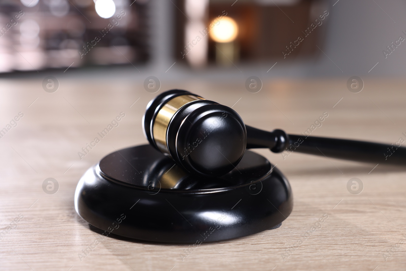Judge's gavel and sound block on wooden table against blurred background, closeup Photo of Judge's gavel and sound block on wooden table against blurred background, closeup