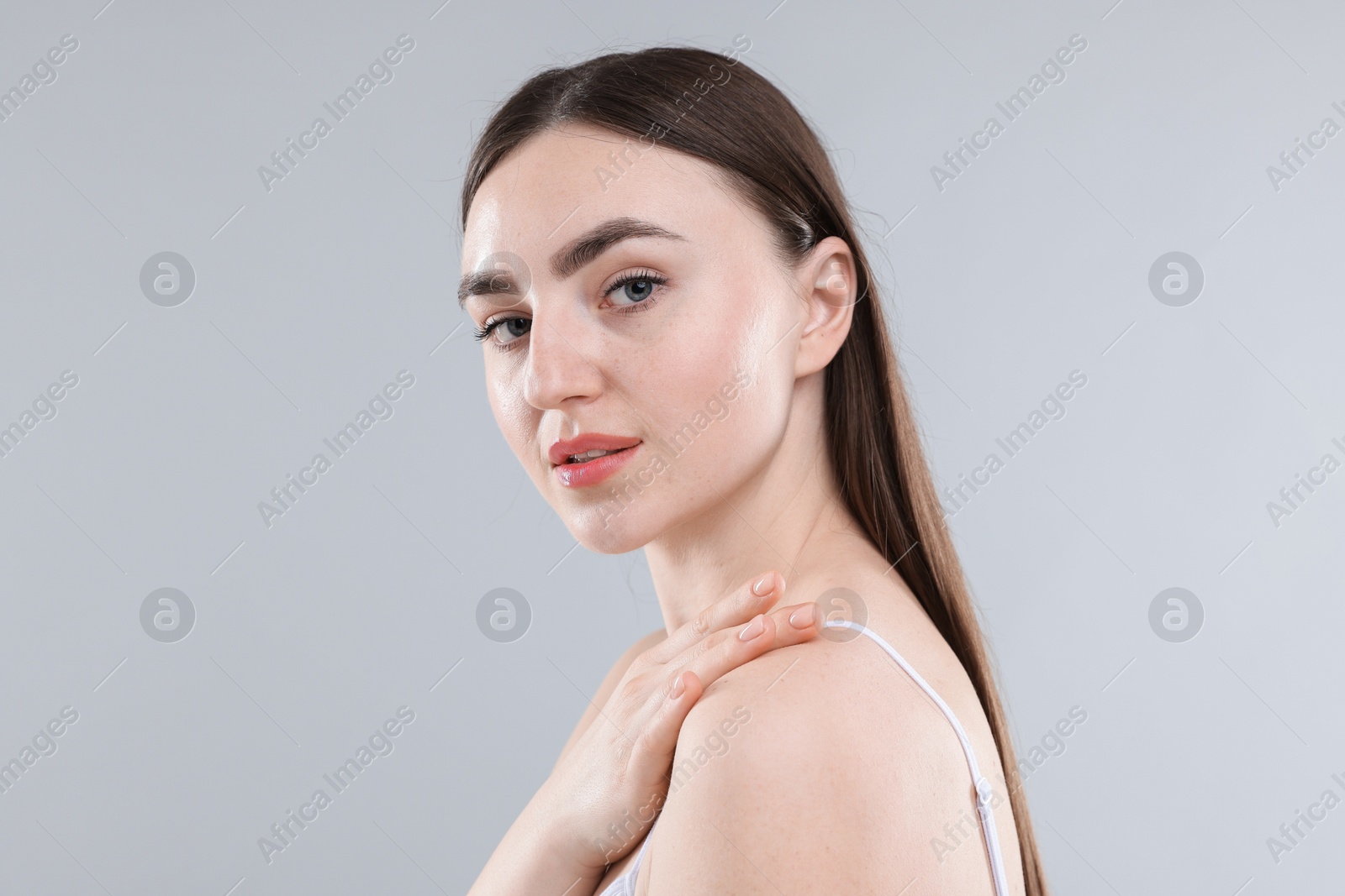Woman with healthy skin on grey background Photo of Woman with healthy skin on grey background