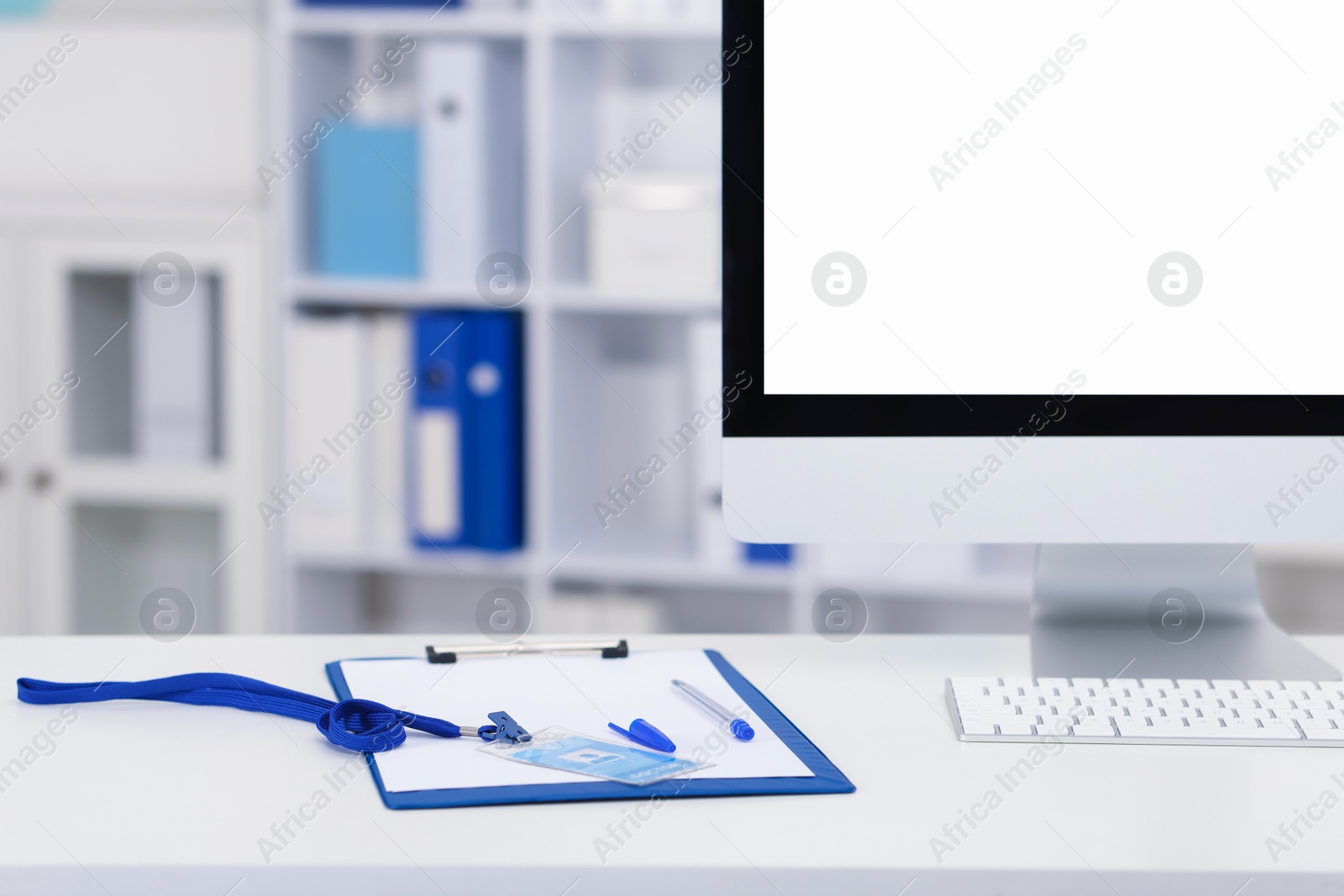 Doctor's workplace with paperwork, badge and computer on desk. Space for text Photo of Doctor's workplace with paperwork, badge and computer on desk. Space for text