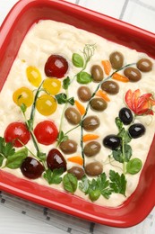 Photo of Raw focaccia with vegetables and olives in baking dish on table, top view