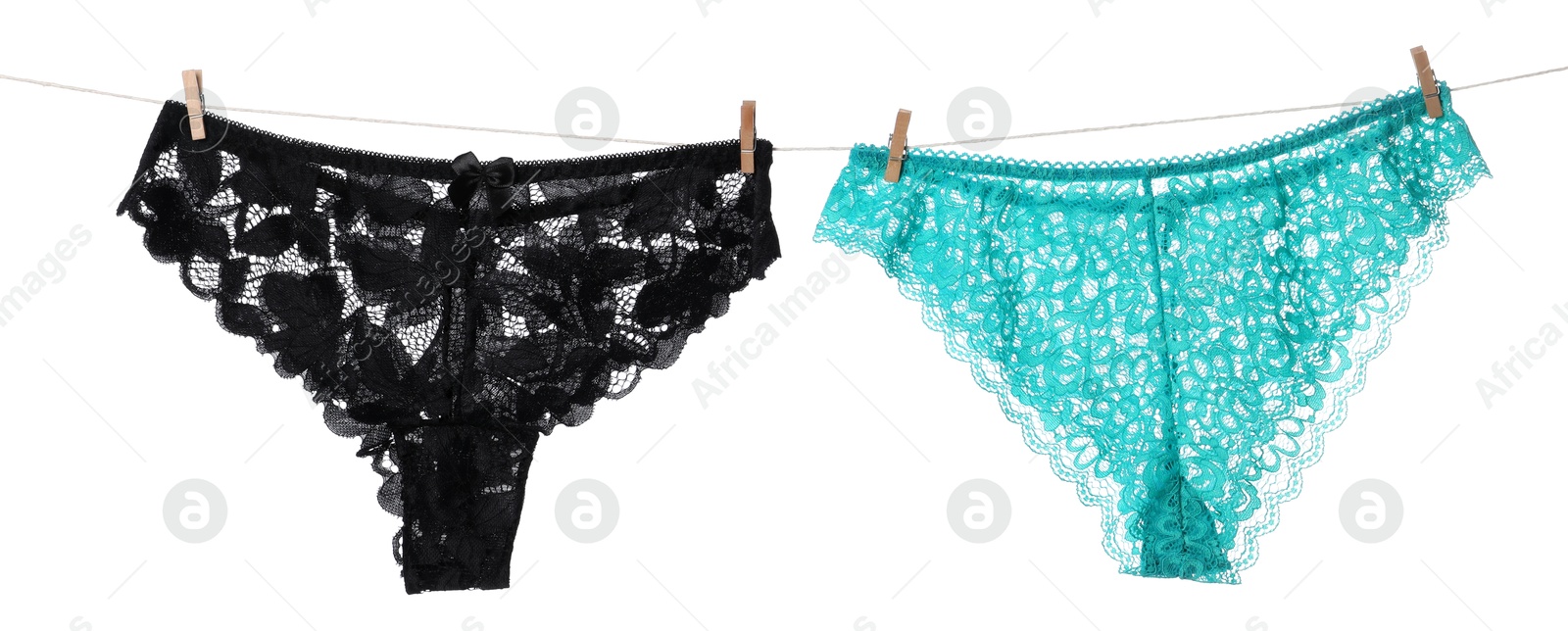 Beautiful panties on clothes line against white background Photo of Beautiful panties on clothes line against white background