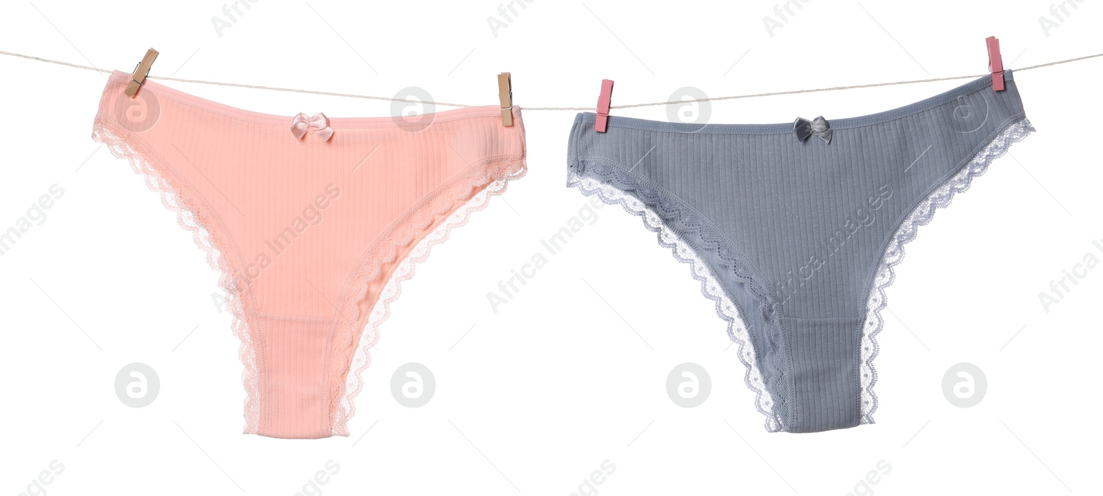 Beautiful panties on clothes line against white background Photo of Beautiful panties on clothes line against white background