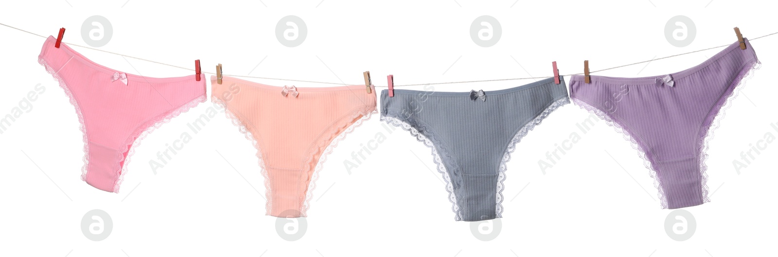 Beautiful panties on clothes line against white background Photo of Beautiful panties on clothes line against white background