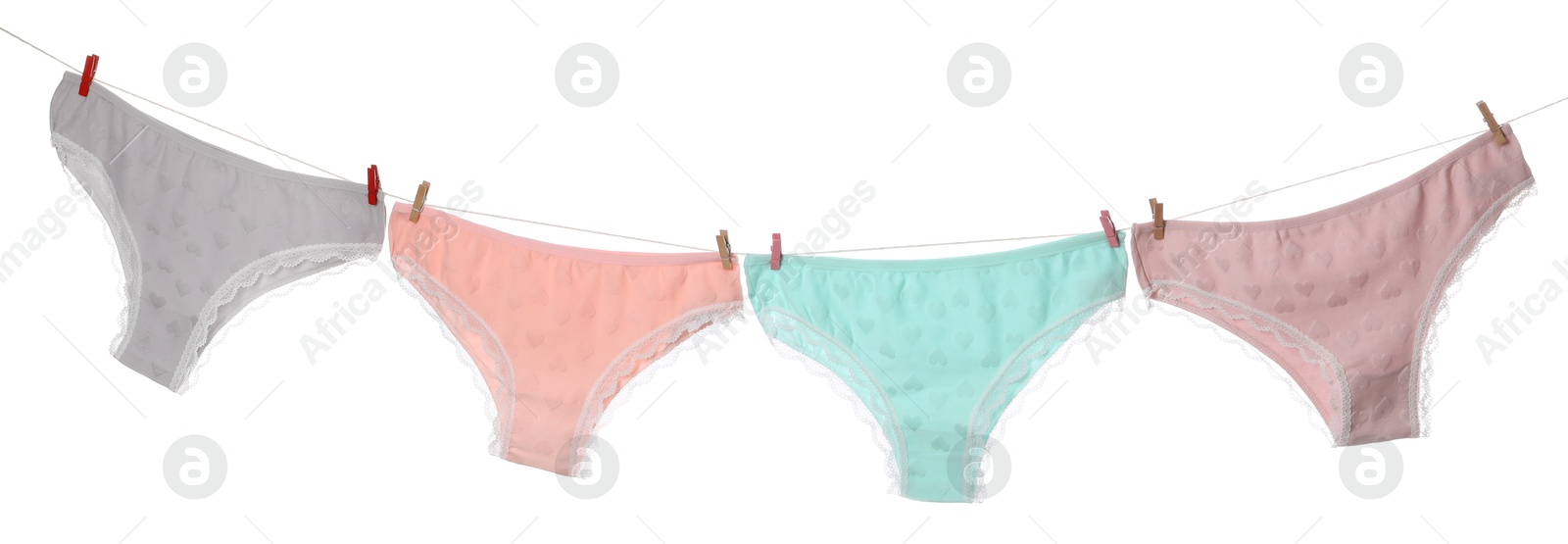 Beautiful panties on clothes line against white background Photo of Beautiful panties on clothes line against white background