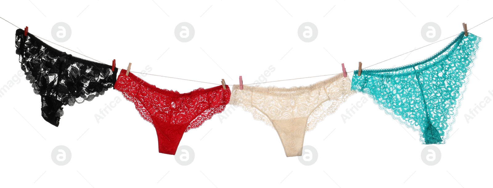 Beautiful panties on clothes line against white background Photo of Beautiful panties on clothes line against white background
