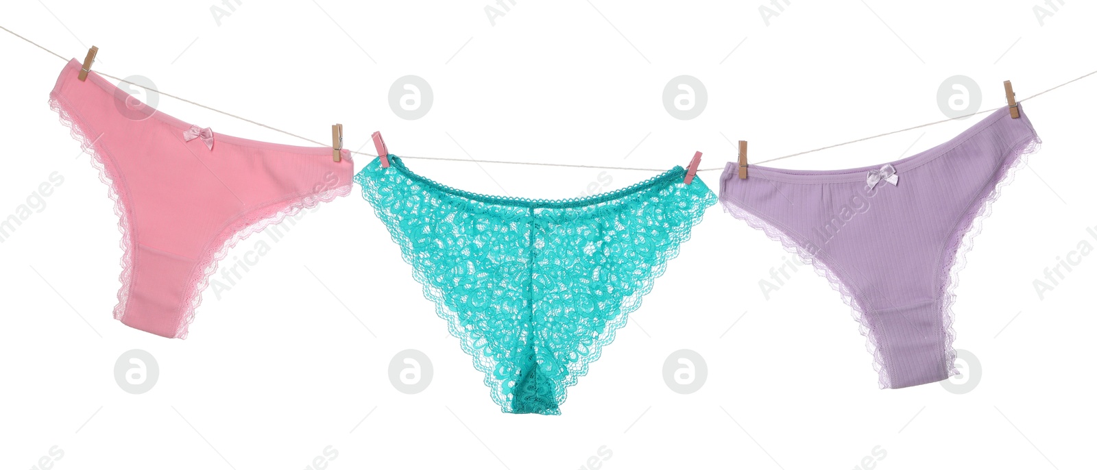 Beautiful panties on clothes line against white background Photo of Beautiful panties on clothes line against white background
