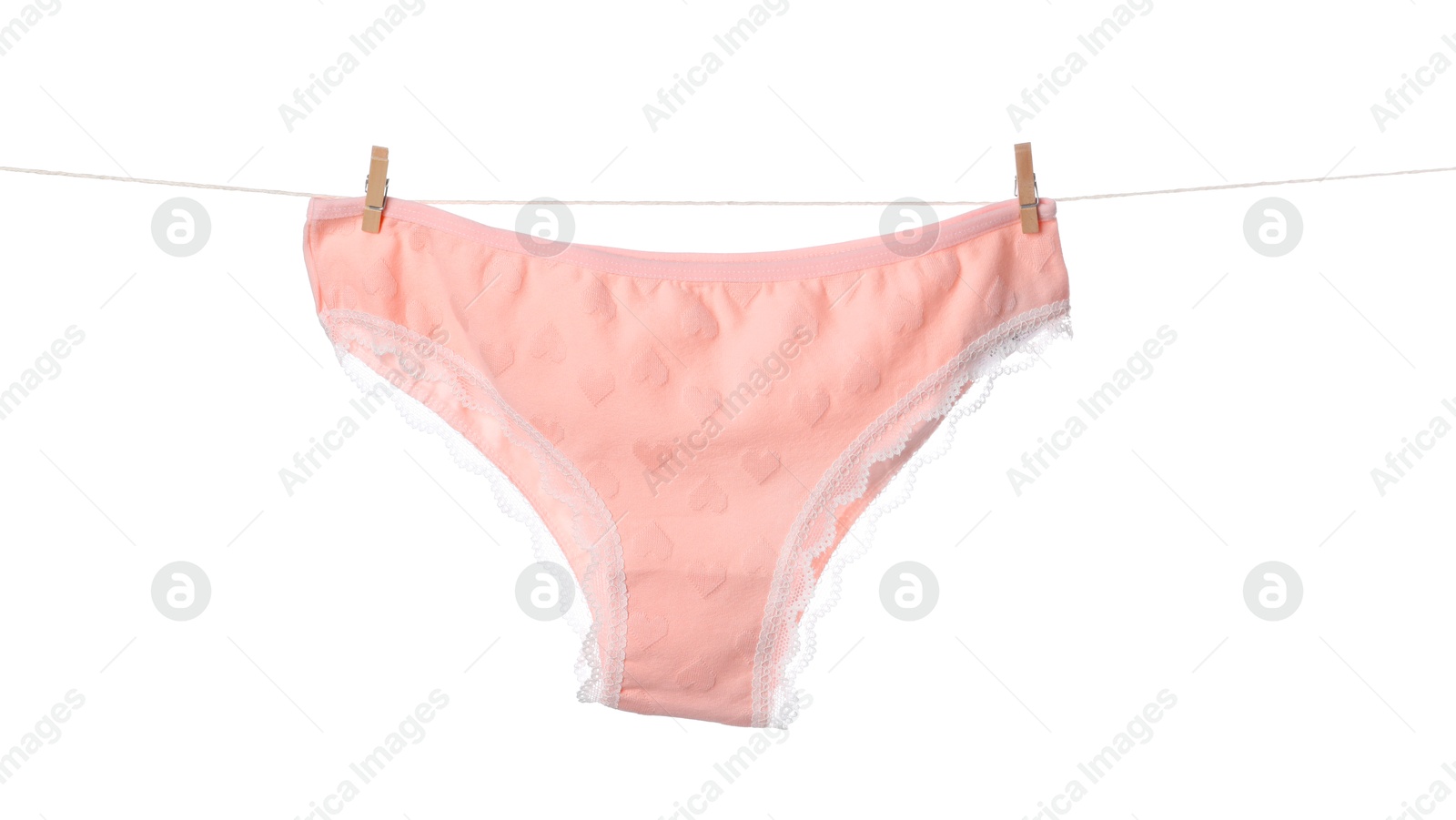 Beautiful panties on clothes line against white background Photo of Beautiful panties on clothes line against white background