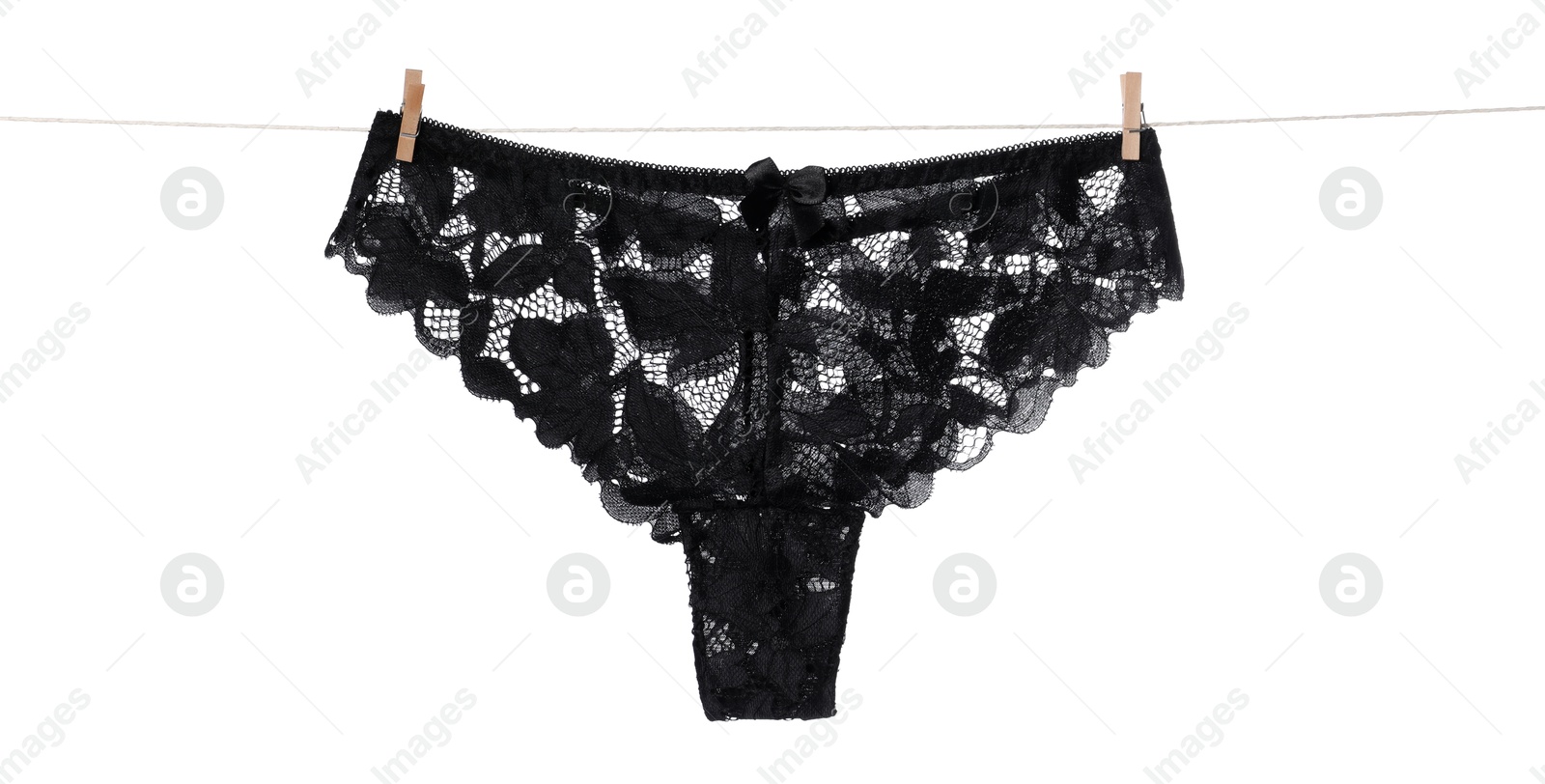 Beautiful panties on clothes line against white background Photo of Beautiful panties on clothes line against white background